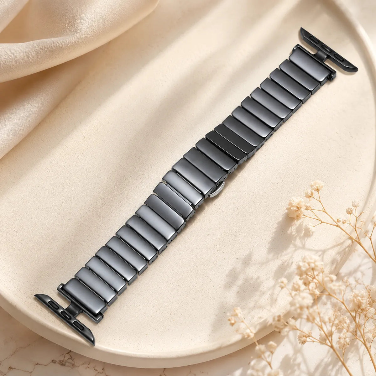 Black ceramic Apple Watch band with open metal connector details