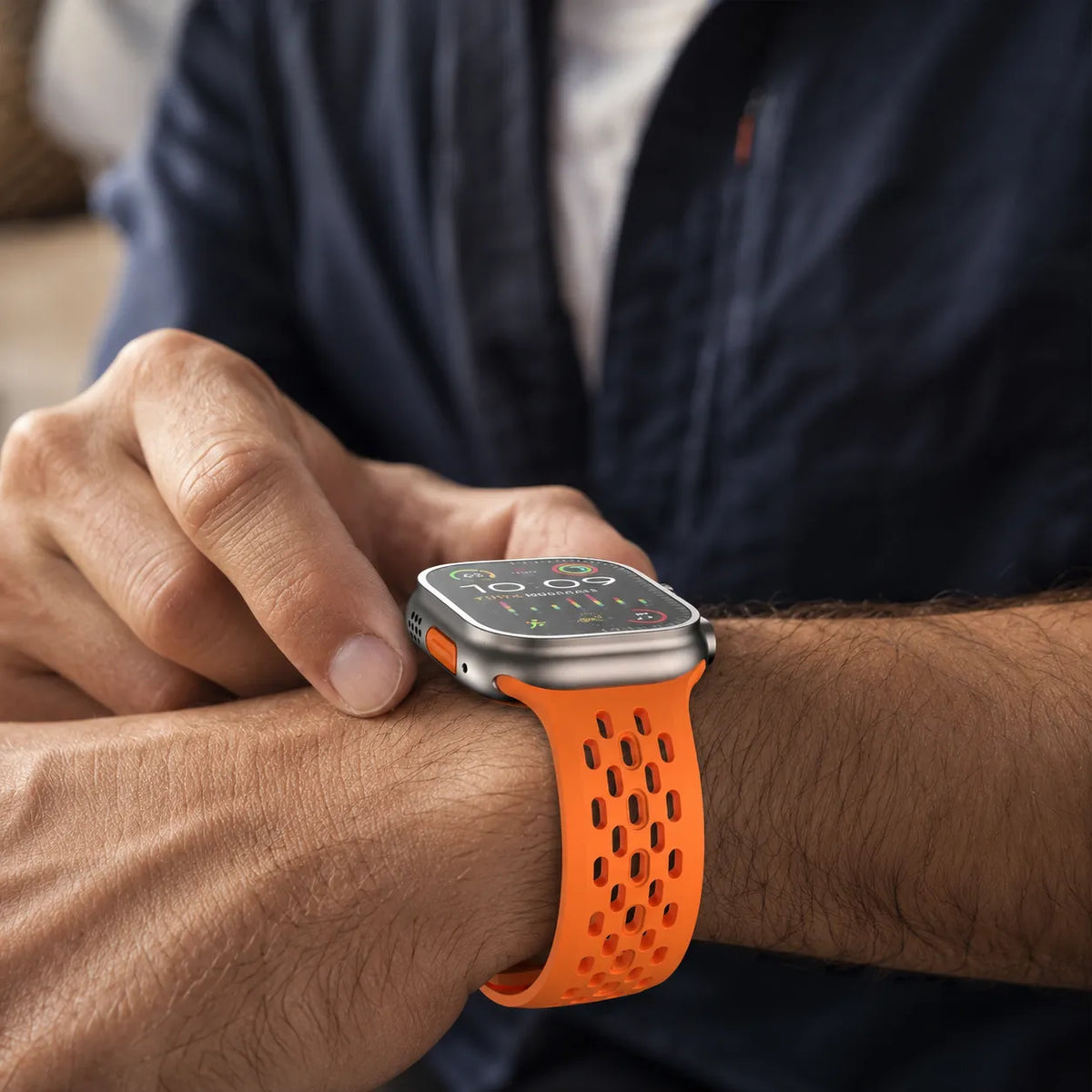Orange breathable FKM Apple Watch band worn with Apple Watch Ultra