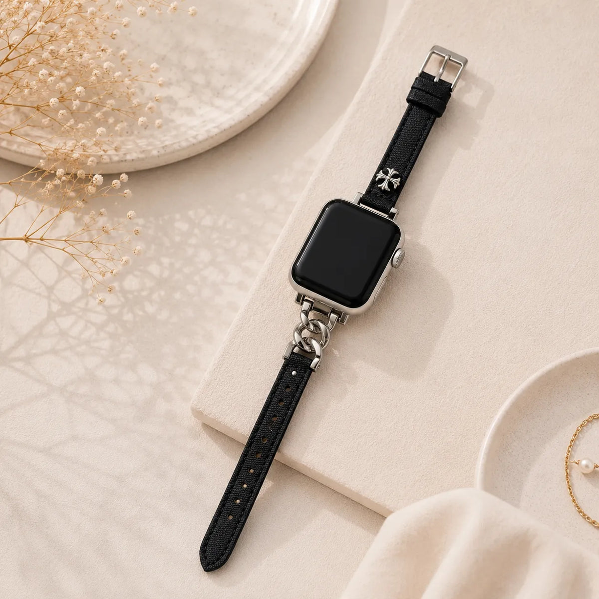 Black leather Apple Watch band with polished chain links and sculpted metal detailing