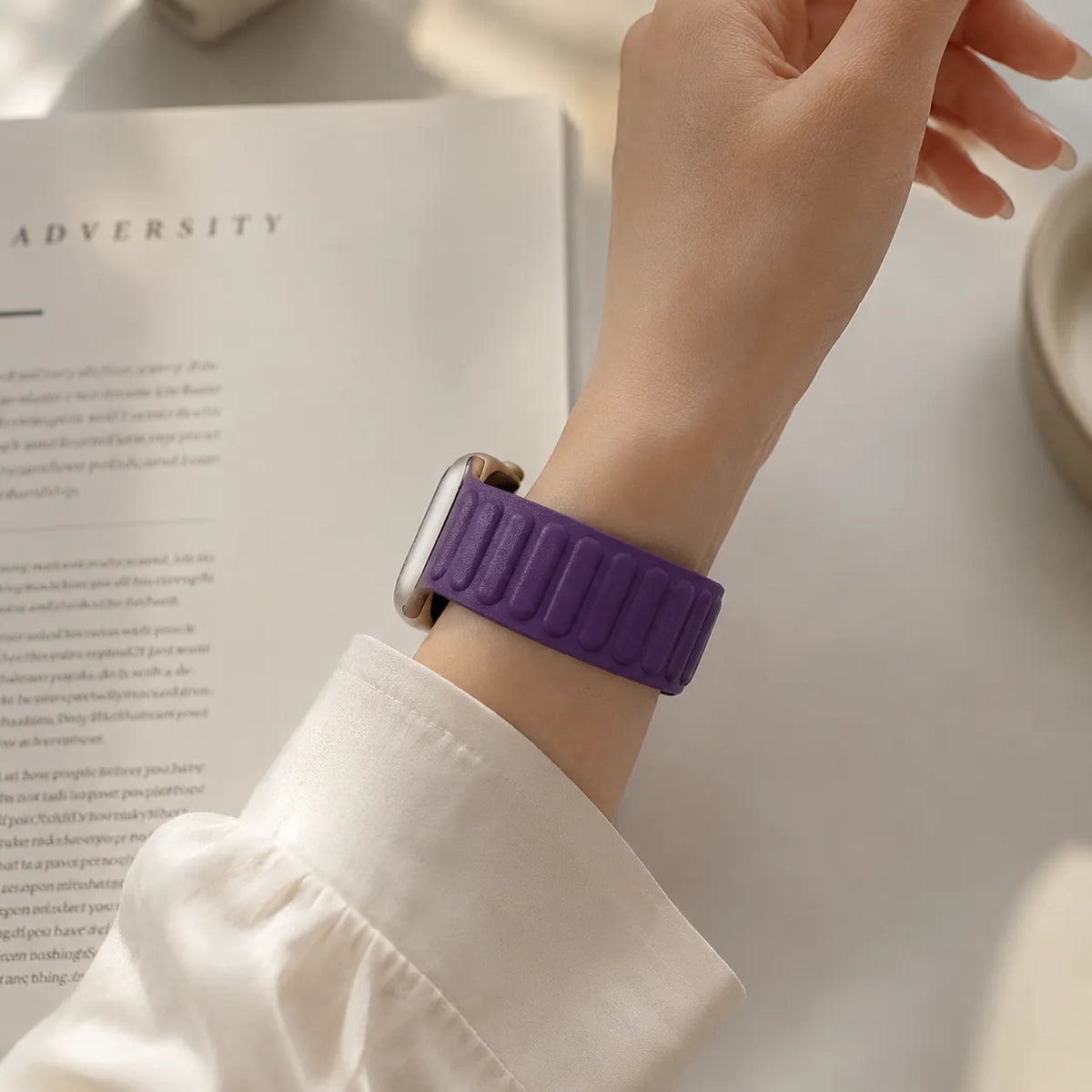 Purple magnetic leather link Apple Watch band worn with a light outfit