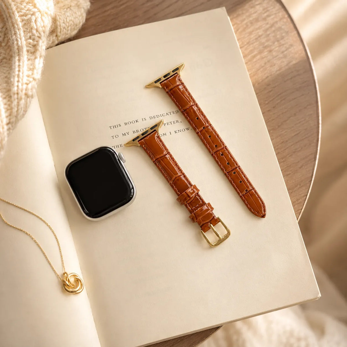 Close view of glossy croc-embossed brown leather Apple Watch band