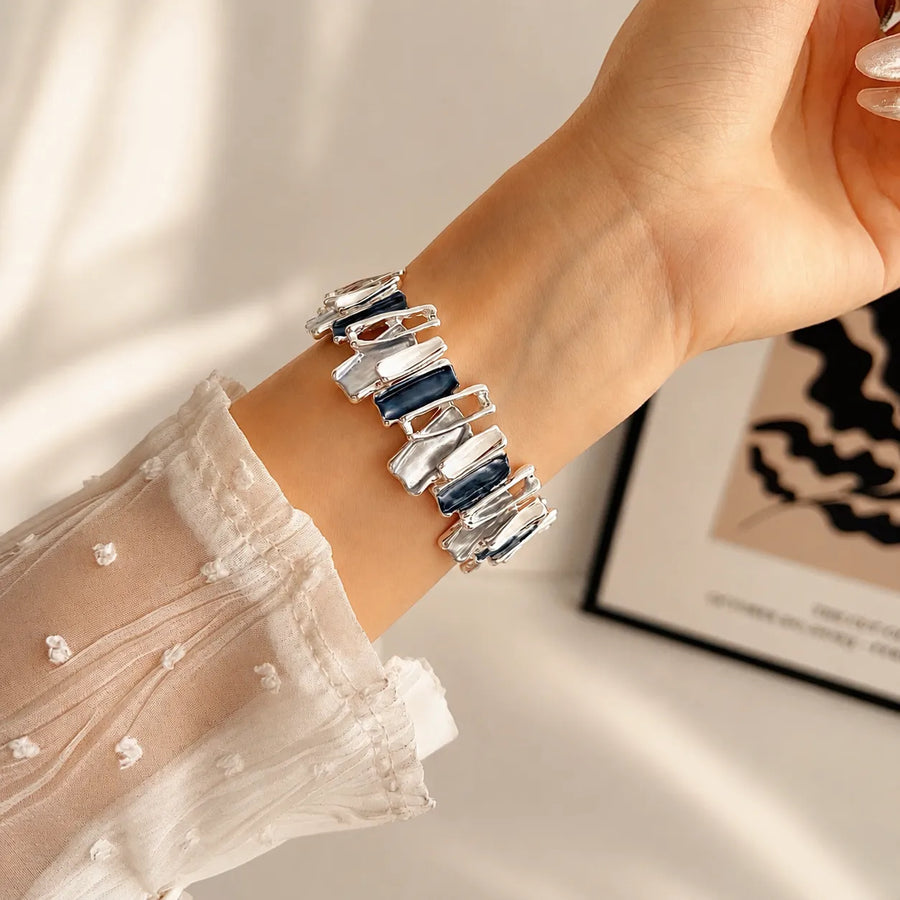 Blue metal scrunchie Apple Watch band worn on the wrist