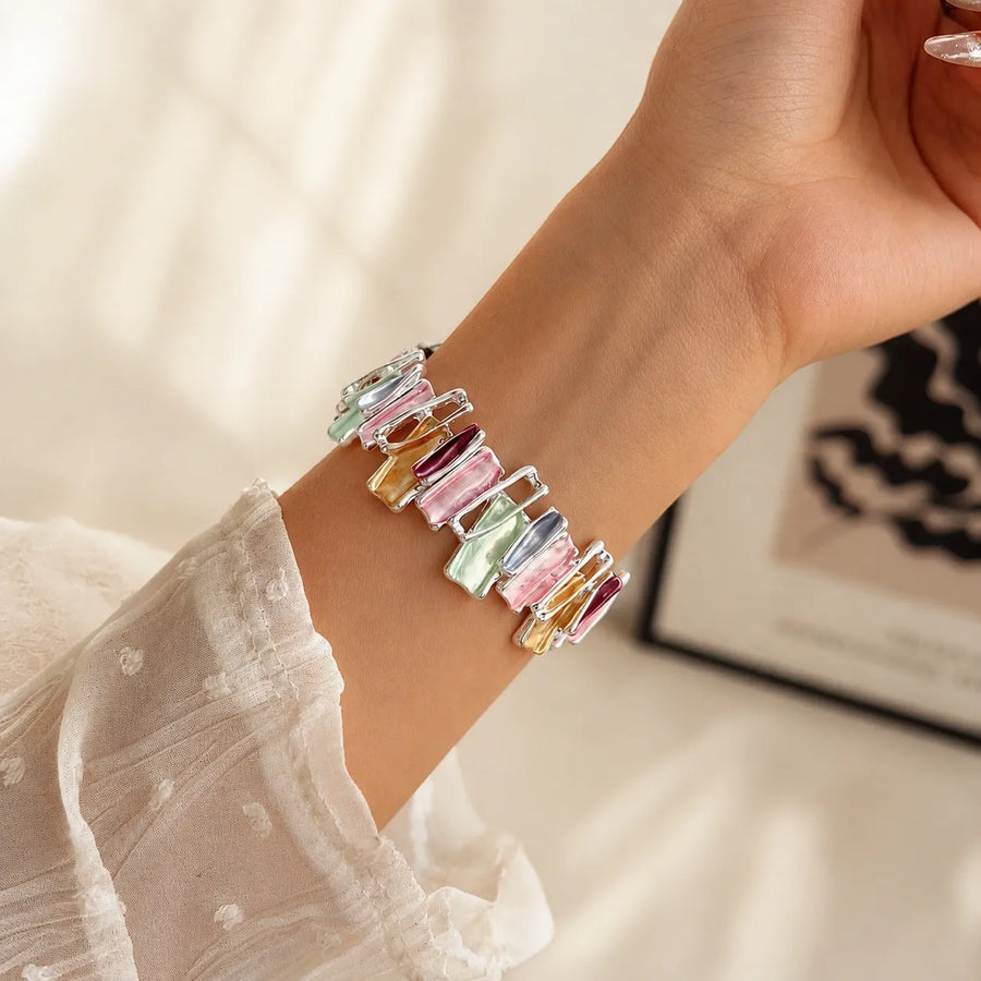 Multicolor metal scrunchie Apple Watch band worn on the wrist