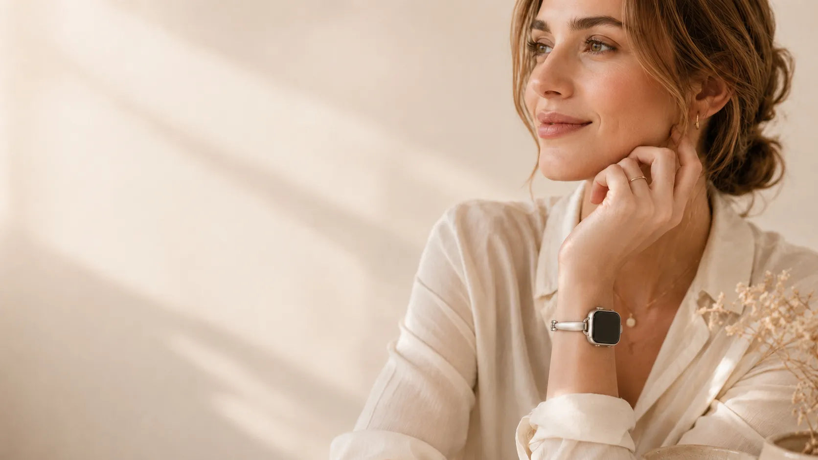 Woman wearing a starlight Breezsy Apple Watch bracelet band